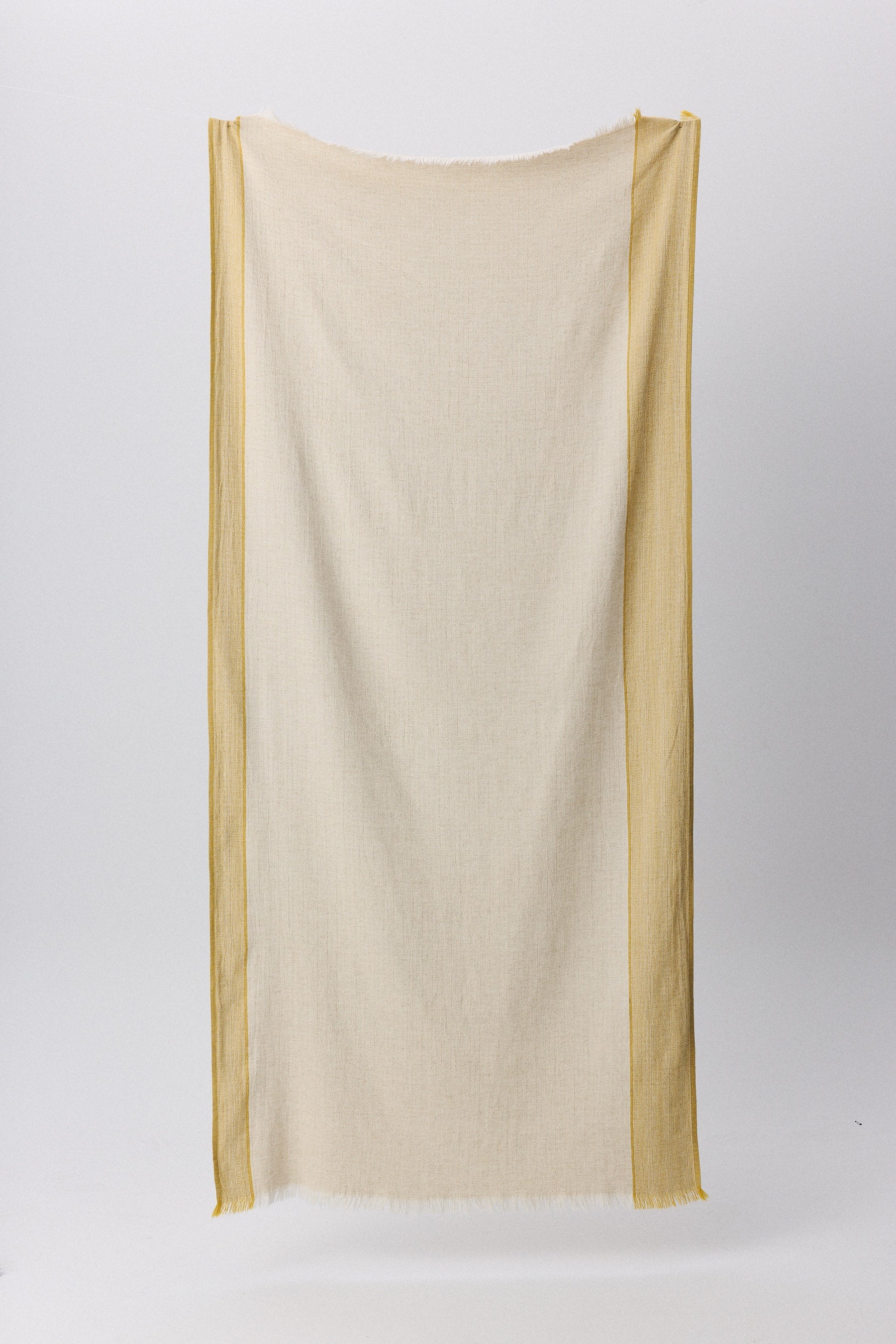 Fuego peshtemal with rustic texture and hand-frayed fringes in natural tones