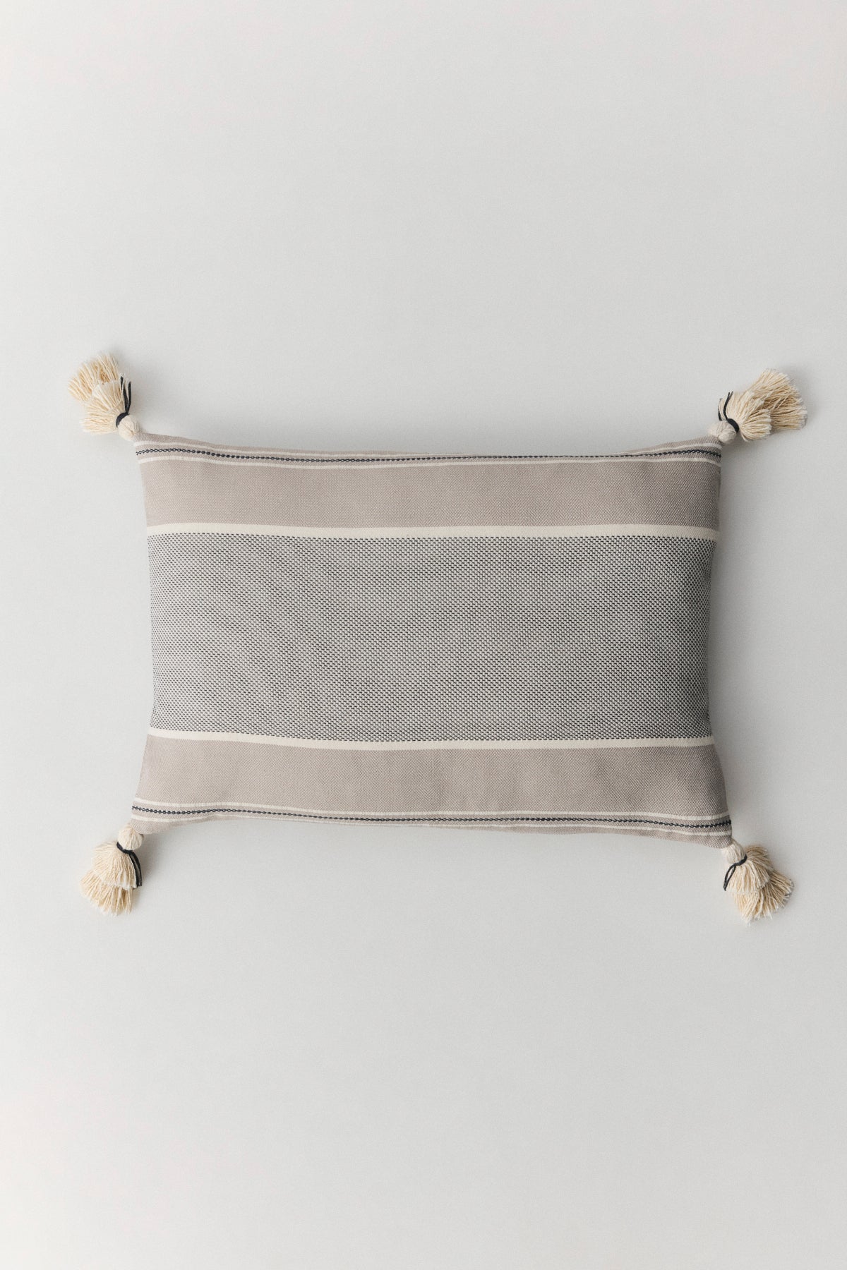 Brunella cotton cushion with handmade pompom details at corners