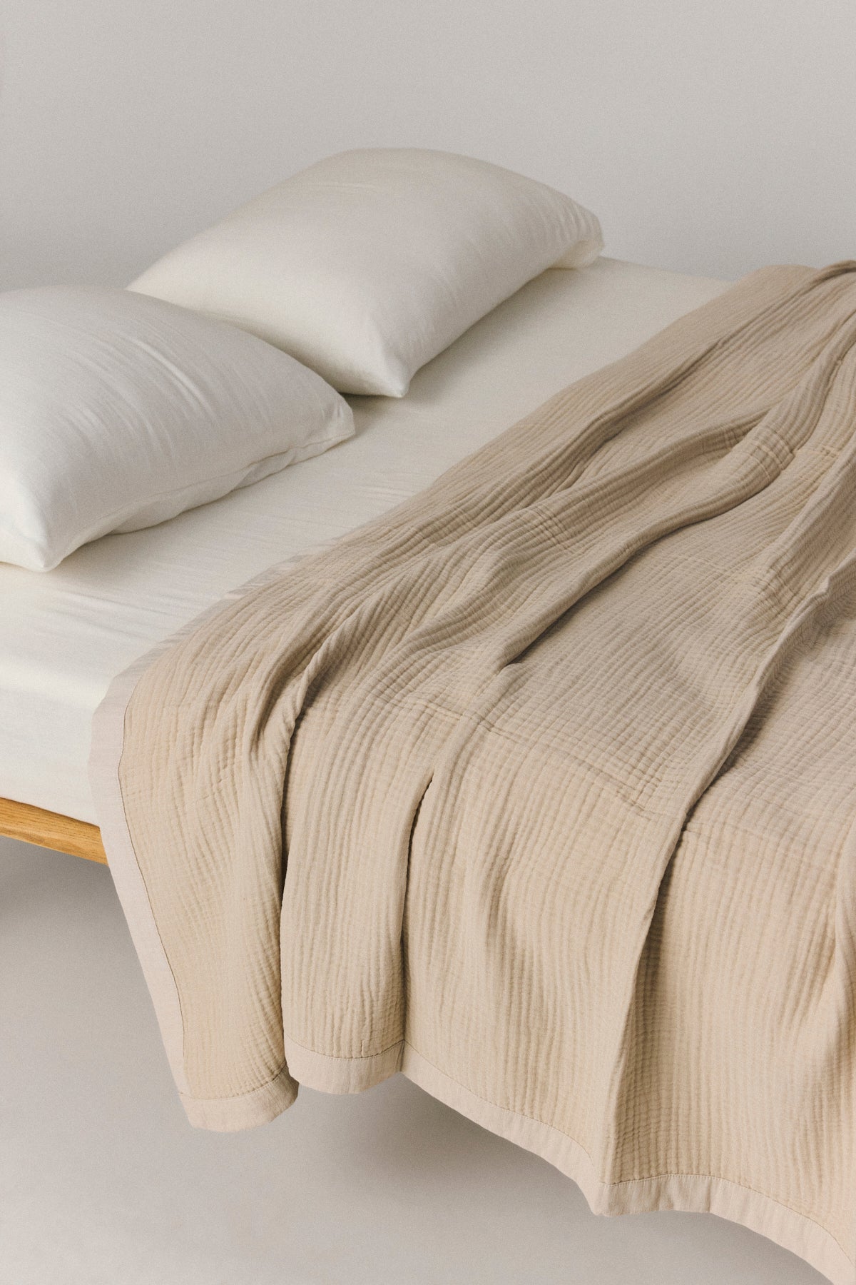 Zen muslin bed cover with layered texture and cotton framed edges