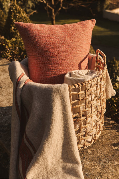 Lana wool throw with contrast stripes and fringed edges draped over sofa