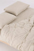 Bliss TENCEL muslin duvet cover set in natural tones on a bed