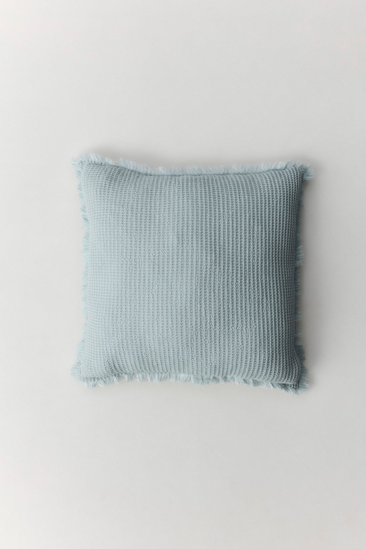 Bohemia Cushion with waffle texture and handmade fringe detail