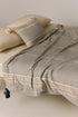 Brunella double-sided throw with cotton and wellsoft, handmade pompom corners