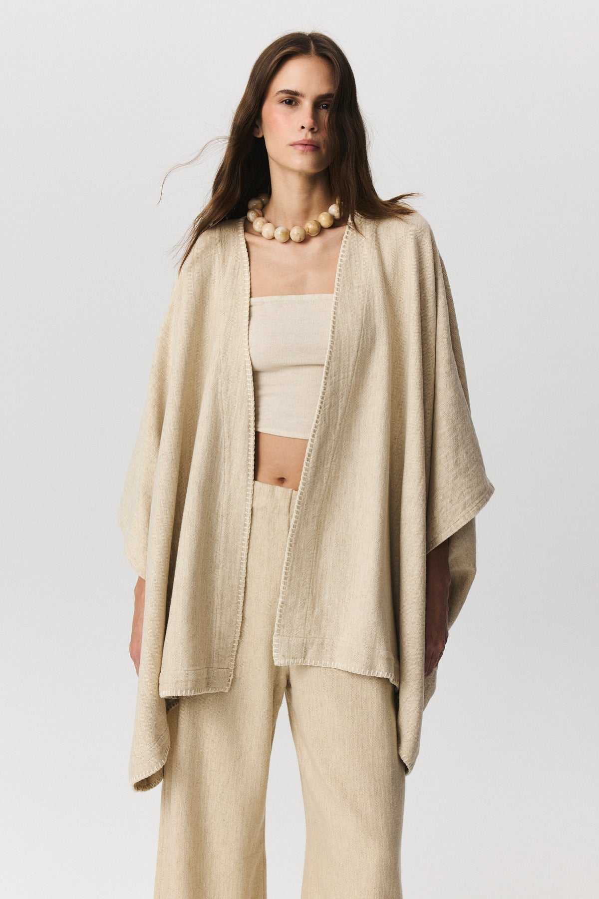 Erica herringbone poncho in linen, cotton and TENCEL™ blend with saddle stitch detail
