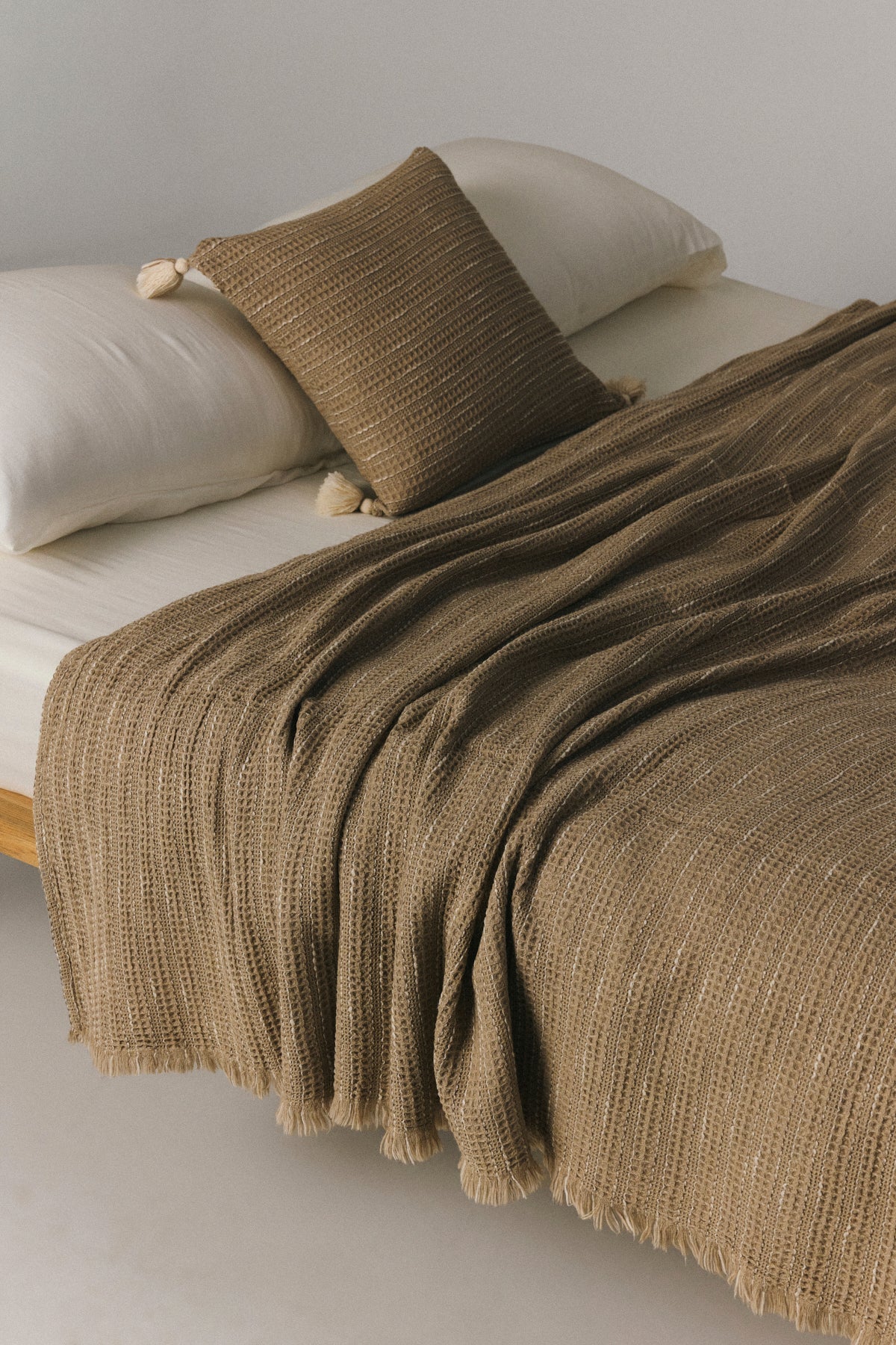 Fresco mélange cotton waffle bedspread in beige on a bed