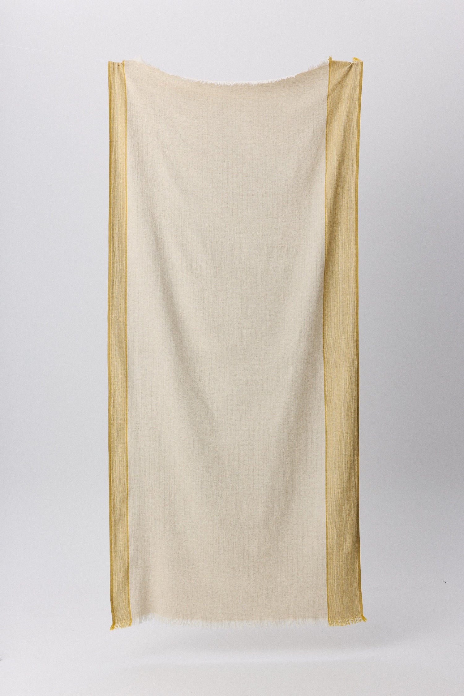 Fuego peshtemal with rustic texture and hand-frayed fringes in natural tones