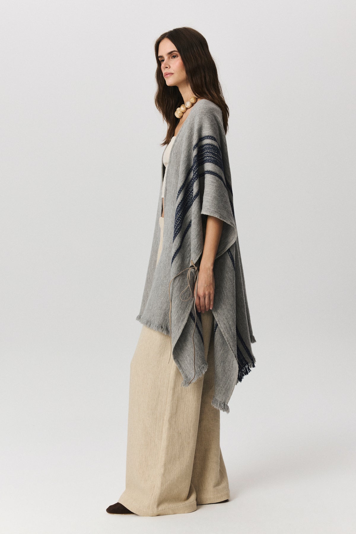 Lana striped wool-blend poncho with side leather cord, unisex