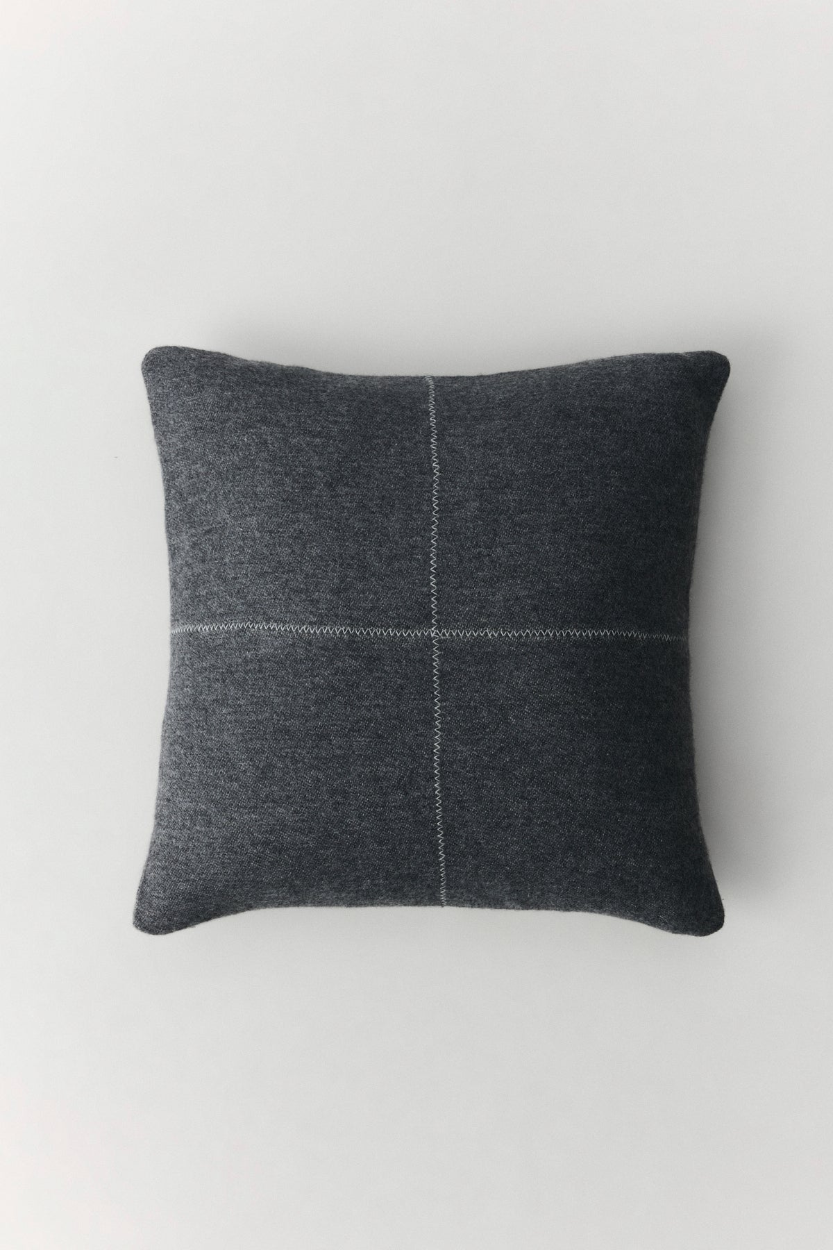 Talin wool cushion with natural texture and decorative zigzag stitching